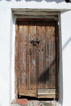 Rustic wooden door in the village centre, Benaque, Andalusia, Spain.