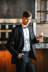A business man holds a glass of wine