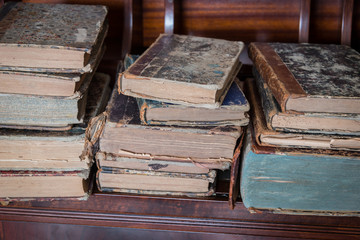 old books placed on wooden shelf