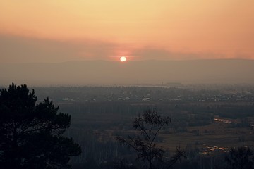 Sunset over the valley in a haze.