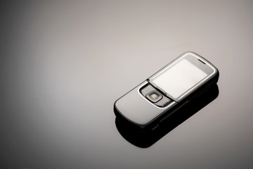 An outdated mobile phone with a screen for copying space on a gray gradient background. The minimalist trend. smartphone. with copy space for text.