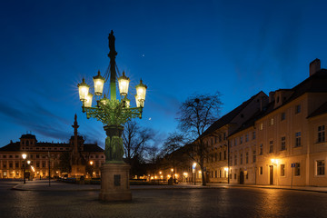 Historic gas street lamp on a Castle square in Prague, Czech Republic. Beautiful ornamental candelabra with 8 arms, technical monument made of cast iron in 1876
