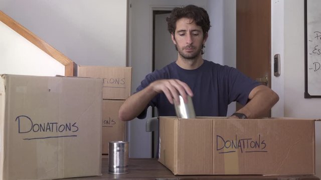 Man preparing boxes of donations