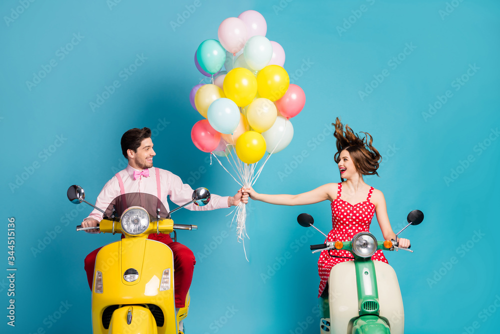 Sticker Photo of funny two people lady guy drive retro moped travelers hold hands many air balloons birthday guests good mood romantic atmosphere vintage clothes isolated blue color background