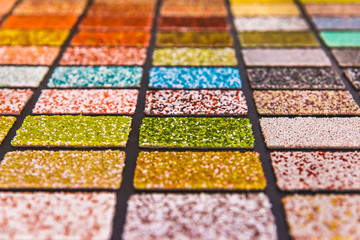 Samples of multi-colored drywall material for the decoration of the facade and interior of buildings