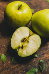 Fresh green apple cutted on the rustic wood table