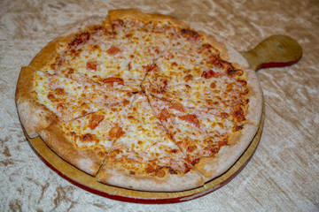Textured surface of cheese pizza with spices. Homemade fresh baking recipe