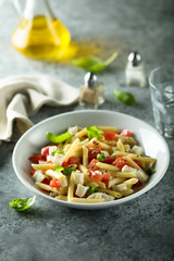 Pasta salad with tomato, mozzarella and basil