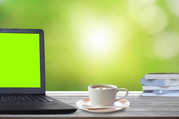 laptop and cup of coffee on wooden table