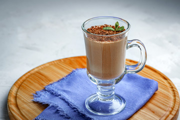 homemade dessert of yogurt and cocoa in a glass bowl on a wooden board