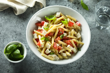 Pasta salad with tomato, mozzarella and basil