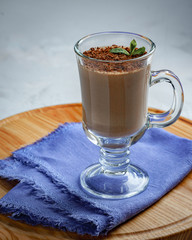 homemade dessert of yogurt and cocoa in a glass bowl on a wooden board