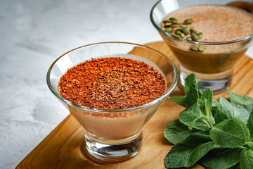 homemade dessert of yogurt and cocoa in a glass bowl on a wooden board
