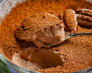 homemade dessert of yogurt and cocoa in a glass bowl on a wooden board