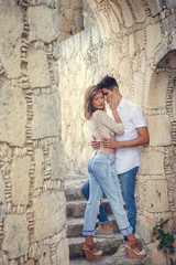 Beautiful sensual portrait of young stylish passionate couple hugging in summer park outdoors. Portrait of hispanic couple outside