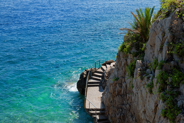Scenic Fisherman Cove in Monaco / Monte-Carlo (Crique des Pêcheurs): Steps leading into colorful...