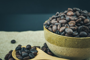 Roasted coffee beans in a wooden spoon.
