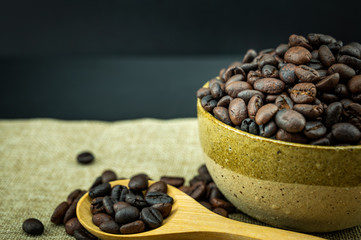 Roasted coffee beans in a wooden spoon.