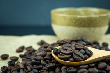 Roasted coffee beans in a wooden spoon.