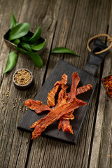 Dried chicken meat with spices on wooden board leaf wooden texture