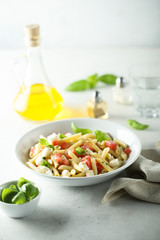 Pasta salad with tomato, mozzarella and basil