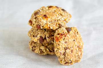 Homemade tasty oatmeal cookies with rasins, dried apricots and date fruits. Healthy snack concept. Sweet dessert. Close up