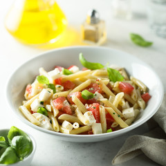 Pasta salad with tomato, mozzarella and basil