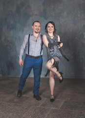 Beautiful woman and handsome man in retro 20 – 30 style dancing