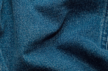 Denim background. Blue background from the texture of blue jeans. Close-up, abstract texture background, space for copying.