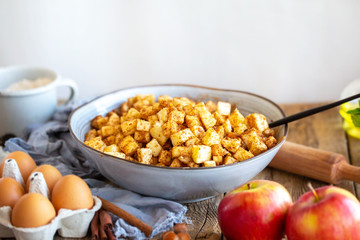 Apple filling with cinnamon and raisins for strudel.Cooking strudel.Cooking apple pie at home. Sliced ​​apples in a bowl with cinnamon and sugar.Cooking together at home. Ingredients for the pie. 