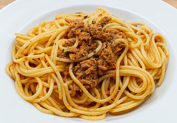 Italian spaghetti with tuna on white dish
