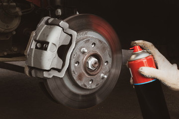 automobile brake disc, pads, caliper assembled by car. car brake repair close up.