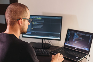 Computer programmer in glasses. Information Technology.  The guy works from home.