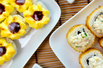 Tempura Maki Sushi-Deep Fried Roll made of Crab Meat, with cucumber. Served on Plate. sushi Japanese cuisine menu