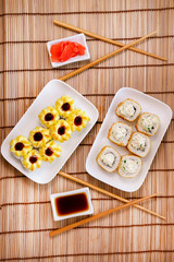 tempura Maki sushi rolls with cream cheese, on a white plate close-up. Deep-fried vertical photo. for two persons