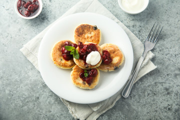 Homemade cottage cheese cakes with cherry sauce