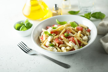 Pasta salad with tomato, mozzarella and basil