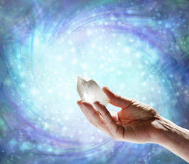 Crystal Therapy Quartz Resonance - male hand pointing a clear quartz terminated crystal upwards...