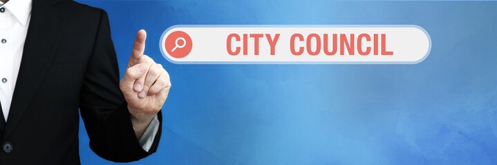 City Council. Lawyer in suit points with his finger to a search box. The term City Council is in...