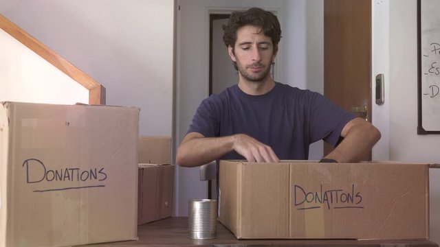 Man preparing boxes of donations