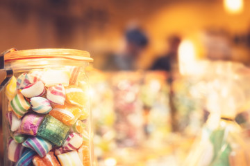 Blur background of delicious sweet beautiful fantasy colourful jar box of candy treat for summer holiday kids gift souvenir. Eat too much bonbon lollipop sugar is toxic unhealthy nutrition addiction