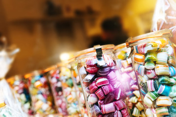 Blur background of delicious sweet beautiful fantasy colourful jar box of candy treat for summer holiday kids gift souvenir. Eat too much bonbon lollipop sugar is toxic unhealthy nutrition addiction