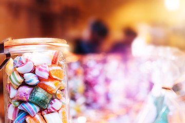 Blur background of delicious sweet beautiful fantasy colourful jar box of candy treat for summer holiday kids gift souvenir. Eat too much bonbon lollipop sugar is toxic unhealthy nutrition addiction