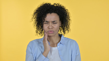 Attractive African Woman having Toothache, Yellow Background