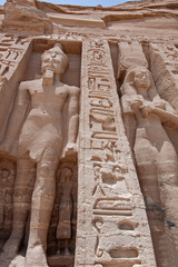 Giant statues of Ramses II and Nefertari at Abu Simbel temple