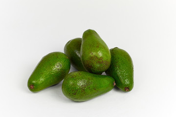 Avocado on white background. Some fresh green ripe avocado. Close up. 