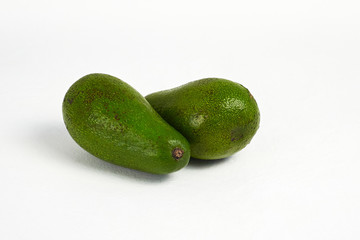 Avocado on white background. Some fresh green ripe avocado. Close up