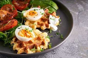 Healthy organic breakfast. Waffles, herbs, tomatoes,salad,eggs, spices served in a plate