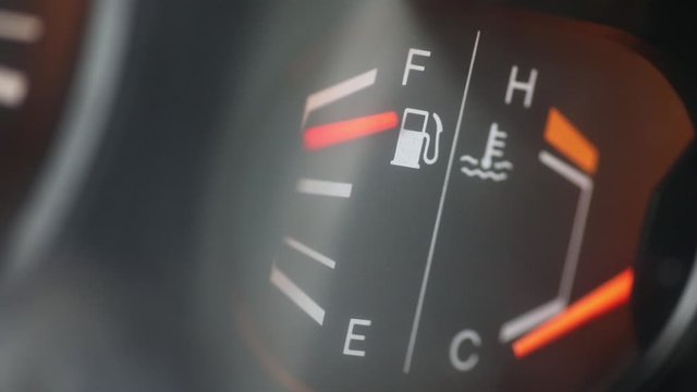 Color HD footage a car's fuel gauge, with the needle going down.