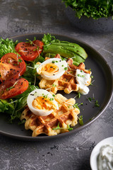 Healthy organic breakfast. Waffles, herbs, tomatoes,salad,eggs, spices served in a plate